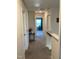 Hallway with neutral walls, carpet, table with flowers, and doorways leading to other rooms, creating flow at 6332 Andante Ave, Raleigh, NC 27616