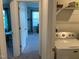 Laundry area with washer, shelves, and doorway leading to a room with natural light, adding convenience and space at 6332 Andante Ave, Raleigh, NC 27616