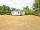 Quaint home boasts a serene backyard with beautiful mature trees at 68 S Grace Way, Henderson, NC 27537
