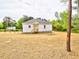 Spacious backyard with a charming home featuring a wood porch and level lot at 68 S Grace Way, Henderson, NC 27537