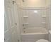 Bathroom featuring a bathtub and shower combination and built-in storage shelves at 68 S Grace Way, Henderson, NC 27537