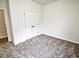 This bedroom features neutral paint, carpet floors, and a double-door closet at 68 S Grace Way, Henderson, NC 27537