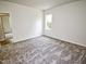 This bedroom features neutral paint, carpet floors, and a window letting in natural light at 68 S Grace Way, Henderson, NC 27537