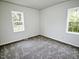 Bright bedroom features neutral carpet, fresh paint and dual windows at 68 S Grace Way, Henderson, NC 27537