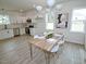 Bright dining area open to the kitchen, featuring stainless steel appliances and modern cabinetry at 68 S Grace Way, Henderson, NC 27537
