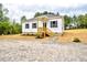 Charming single-story home with white siding, black shutters, and a cozy front porch at 68 S Grace Way, Henderson, NC 27537