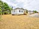 New home features black shutters, level lot and manicured front yard at 68 S Grace Way, Henderson, NC 27537