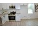 This kitchen has granite countertops, stainless steel appliances, and crisp white cabinetry at 68 S Grace Way, Henderson, NC 27537