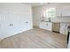 Bright kitchen with white cabinets, stainless steel appliances, and ample counter space at 68 S Grace Way, Henderson, NC 27537
