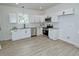 Modern kitchen featuring white cabinets, stainless steel appliances, and sleek countertops at 68 S Grace Way, Henderson, NC 27537