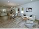 Bright, open-concept living room featuring modern decor, sleek flooring, and lots of natural light at 68 S Grace Way, Henderson, NC 27537