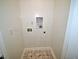 This utility room features tile floors, neutral paint, and hookups for a washer and dryer at 68 S Grace Way, Henderson, NC 27537