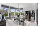 Inviting dining area with a view of outdoor scenery through big windows and contemporary stylish accents at 687 Bandon Aly, Cary, NC 27513