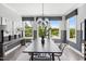 Well-lit dining area with modern light fixture, large windows providing exterior view and stylish decorations at 687 Bandon Aly, Cary, NC 27513