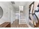 Inviting entryway featuring hardwood floors, a staircase, and stylish decor at 687 Bandon Aly, Cary, NC 27513