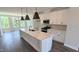 Modern kitchen features an island, stainless steel appliances and a dining area with lots of natural light at 687 Bandon Aly, Cary, NC 27513