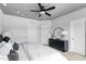 Neutral primary bedroom features a ceiling fan, dresser, and decorative mirror at 687 Bandon Aly, Cary, NC 27513