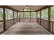 Relaxing back porch with wooden floors and views of the private backyard at 706 Mossburn Ct, Fuquay Varina, NC 27526