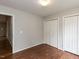This bedroom is complete with hardwood floors, a neutral palette, and multiple closets at 706 Mossburn Ct, Fuquay Varina, NC 27526