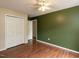 Large bedroom features hardwood floors, a ceiling fan, and closet at 706 Mossburn Ct, Fuquay Varina, NC 27526