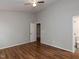 The bedroom features hardwood floors, a neutral palette, and an ensuite bath at 706 Mossburn Ct, Fuquay Varina, NC 27526