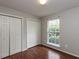Bedroom with hardwood floors, natural light, and ample closet space at 706 Mossburn Ct, Fuquay Varina, NC 27526