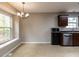 Dining area featuring a modern chandelier and a large window overlooking the backyard at 706 Mossburn Ct, Fuquay Varina, NC 27526