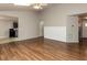 Large living room featuring hardwood floors and easy access to the kitchen at 706 Mossburn Ct, Fuquay Varina, NC 27526