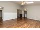 Open living room showcasing hardwood floors, wainscoting, and access to laundry room at 706 Mossburn Ct, Fuquay Varina, NC 27526