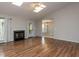 Spacious living room featuring a fireplace, hardwood floors, and natural light from skylights at 706 Mossburn Ct, Fuquay Varina, NC 27526