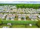Aerial view featuring many homes and a large stretch of green vegetation at 72 E Moss Creek Dr, Clayton, NC 27520