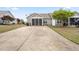 Exterior of home featuring backyard with long driveway and covered porch at 72 E Moss Creek Dr, Clayton, NC 27520