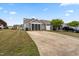Back exterior of home, long driveway with a view of a screened porch at 72 E Moss Creek Dr, Clayton, NC 27520