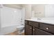 Bright bathroom featuring a tub/shower combo and dark vanity with sink at 72 E Moss Creek Dr, Clayton, NC 27520