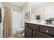 This full bathroom features a tub/shower combo, dark vanity and sink, and tile flooring at 72 E Moss Creek Dr, Clayton, NC 27520