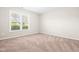 This bedroom has neutral carpet, a window overlooking the neighborhood, and is ready for decor at 72 E Moss Creek Dr, Clayton, NC 27520