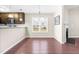 Open dining space with hardwood floors and view of the kitchen and yard at 72 E Moss Creek Dr, Clayton, NC 27520