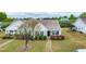 Charming single-story home with a well-manicured lawn and mature landscaping at 72 E Moss Creek Dr, Clayton, NC 27520