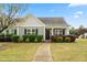 Charming single-story home with a well-manicured lawn and colorful landscaping at 72 E Moss Creek Dr, Clayton, NC 27520