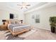 Spacious main bedroom features a tray ceiling, ceiling fan, and natural light at 72 E Moss Creek Dr, Clayton, NC 27520