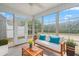 This sunroom features many windows with a view, and cushioned outdoor furniture at 72 E Moss Creek Dr, Clayton, NC 27520