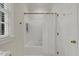 Bathroom showcasing a bathtub with white tiled wall and bright window at 7709 Oakmont Pl, Raleigh, NC 27615