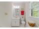 Bright bathroom featuring a vanity, toilet, and window with natural light at 7709 Oakmont Pl, Raleigh, NC 27615