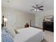 Neutral bedroom featuring a bed with a ceiling fan and television on the dresser at 7709 Oakmont Pl, Raleigh, NC 27615