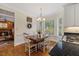 Bright dining area boasts natural light, hardwood floors, and backyard views from bay windows at 7709 Oakmont Pl, Raleigh, NC 27615