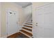 Entryway featuring a hardwood floor and staircase with a door to the garage at 7709 Oakmont Pl, Raleigh, NC 27615