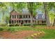 Charming brick home with manicured lawn, lush landscaping and a welcoming front porch at 7709 Oakmont Pl, Raleigh, NC 27615