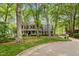 Beautiful brick home with mature trees, manicured lawn, and covered front porch at 7709 Oakmont Pl, Raleigh, NC 27615