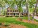 Charming brick home with manicured lawn, lush landscaping and a welcoming front porch at 7709 Oakmont Pl, Raleigh, NC 27615