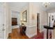 Bright hallway with hardwood floors, detailed trim, and elegant lighting at 7709 Oakmont Pl, Raleigh, NC 27615